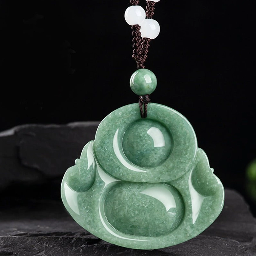 Rear carved design of cyan jade laughing Buddha pendant, showing intricate back detail with beaded cord