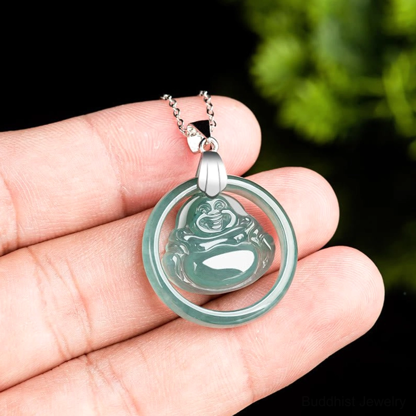 Laughing Buddha jade pendant size reference - mini jade charm on human finger for scale with silver metal bail