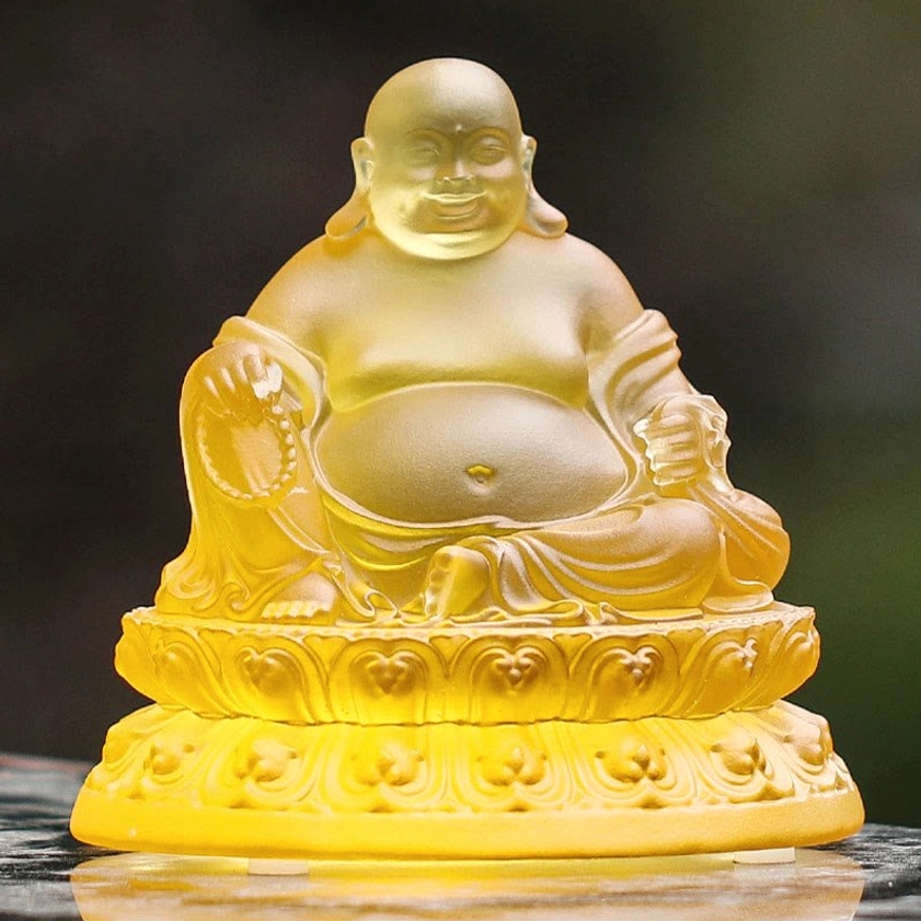 Close-up front view of Laughing Buddha Liuli crystal face showing big belly iconography warm amber frosted glass finish