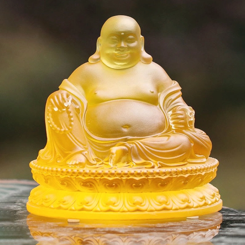 Seated Laughing Buddha Liuli crystal figurine front eye-level view intricate robe carving amber yellow glass lotus throne