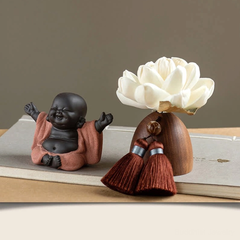 Laughing Buddha Maitreya smiling with spread arms in reddish-brown robe on desk decoration