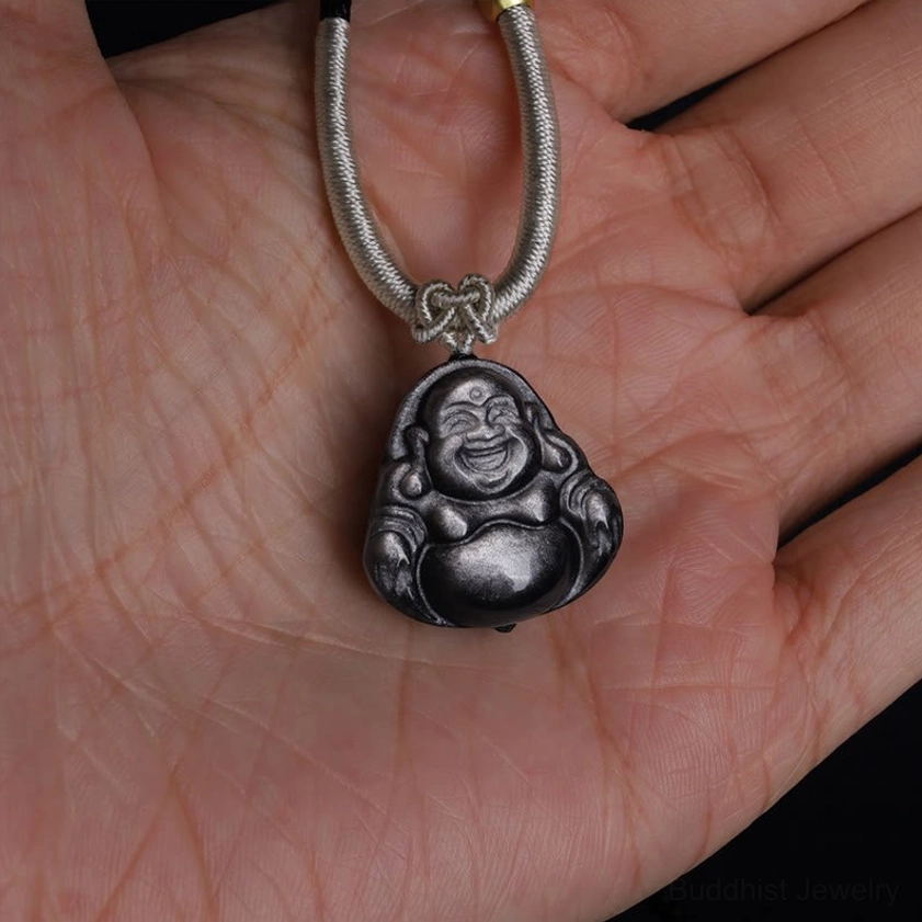 Laughing Buddha obsidian necklace overhead view on palm, light grey braided cord with simple knot at pendant connection
