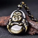 Gold sheen obsidian Laughing Buddha pendant close-up front view showing glossy black stone with golden shimmer and intricate carved Buddha face