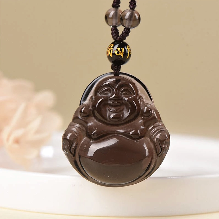 Laughing Buddha obsidian pendant on decorative cord with gold-scripted accent beads close-up