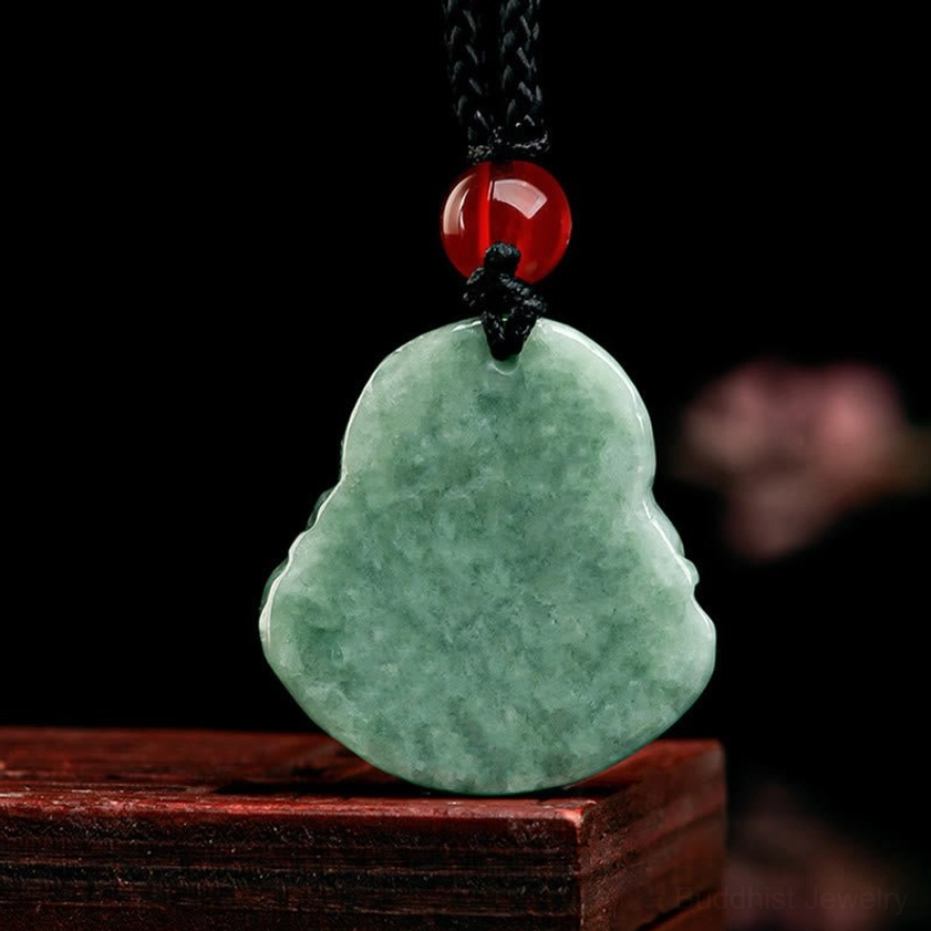 Back of natural green jade Laughing Buddha pendant showing smooth carved surface and hanging hole