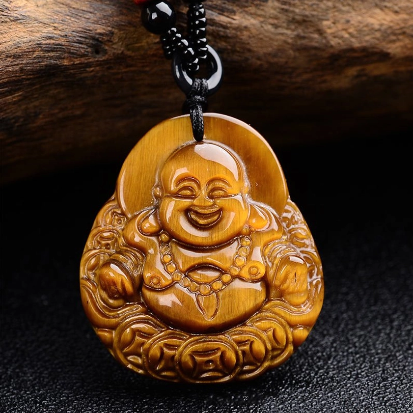 Laughing Buddha pendant close-up showing detailed carving, coin border design and tiger eye stone texture