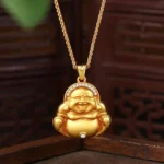 Laughing Buddha gold pendant necklace front view with zircon inlays and Fu character carving on traditional wooden background