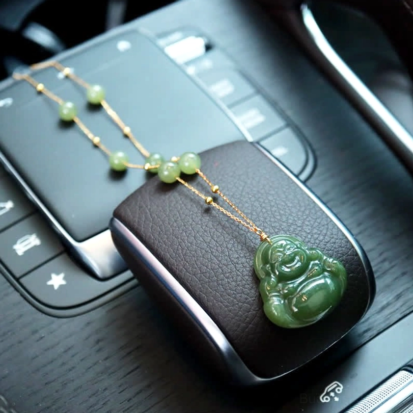Hetian jade Laughing Buddha pendant necklace with polished dark green stone and 18K gold chain, car interior lifestyle shot