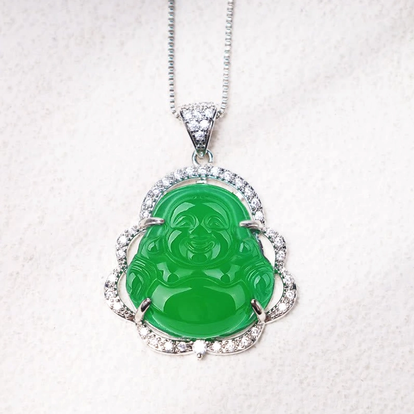 Green jade laughing Buddha silver pendant with detailed cubic zirconia bail and halo, flat close-up view