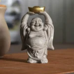 Laughing Buddha resin statue front view holding golden ingot, sandy gray handmade sculpture for home blessing and good fortune