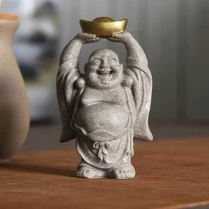 Laughing Buddha resin statue front view holding golden ingot, sandy gray handmade sculpture for home blessing and good fortune