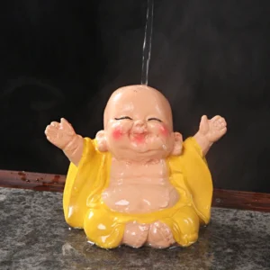 Color-changing laughing Buddha tea pet with steaming hot water on marble tea table, yellow robe transforming in real-time