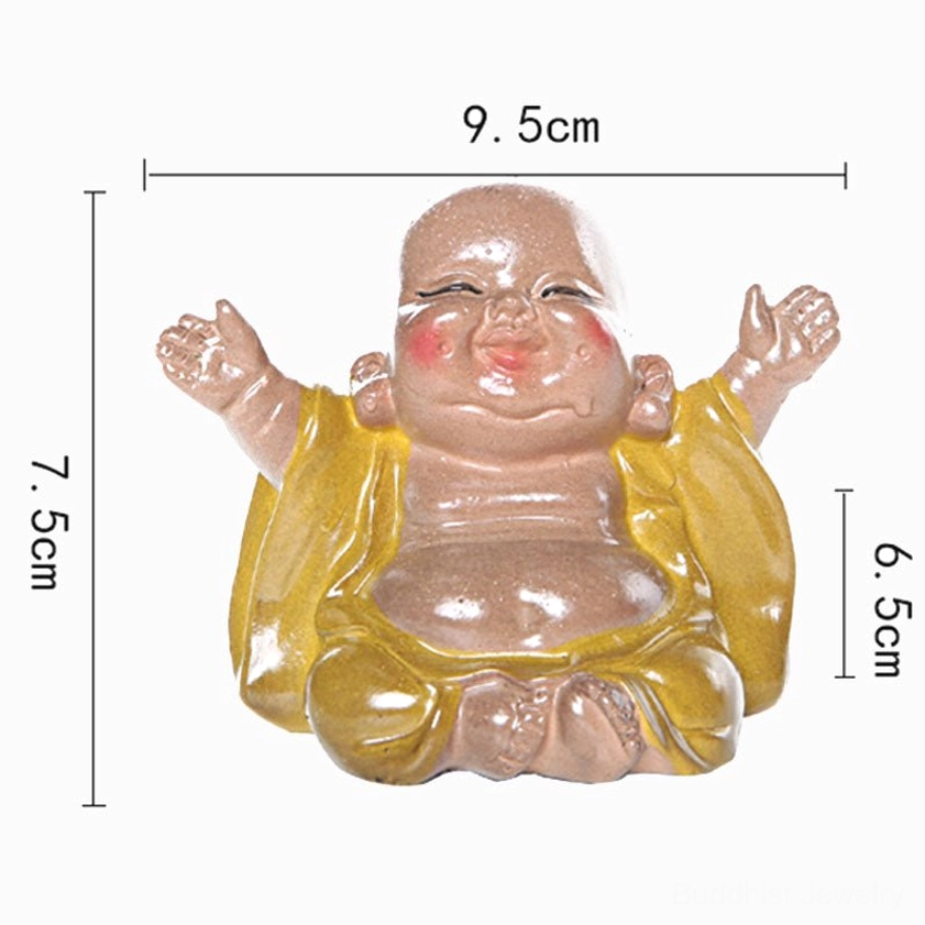 Laughing Buddha tea pet in elegant tea ceremony setting surrounded by teacups and traditional Chinese tea culture elements