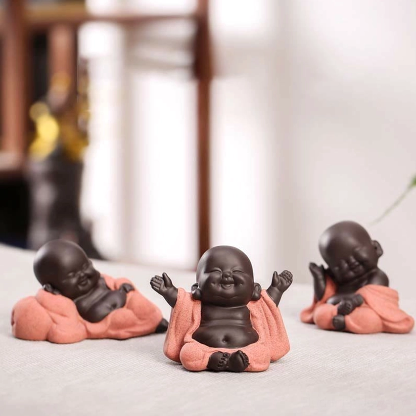 Three-piece Buddha figurine set overhead group view showing multiple pose variants, collection display on shelf