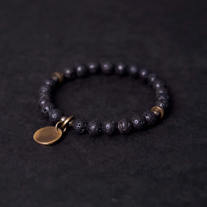 Lava rock grounding bracelet side angle view showing textured porous volcanic beads with antique bronze hardware and disc charm