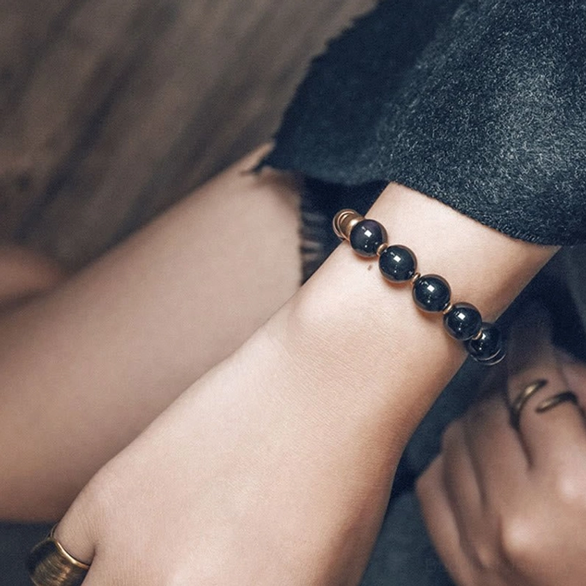 Lava rock stone and brass beaded bracelet with elastic cord, showing durability and comfortable wearability