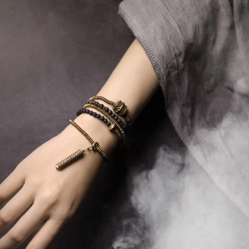 Full lava rock and brass layered bracelet set on hand and wrist - side angle styling view