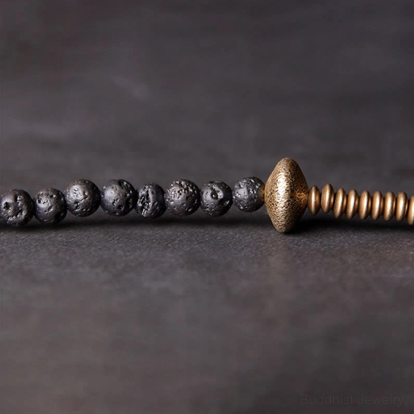 Lava rock beads with brass spacer accents - flat lay strand close-up texture detail