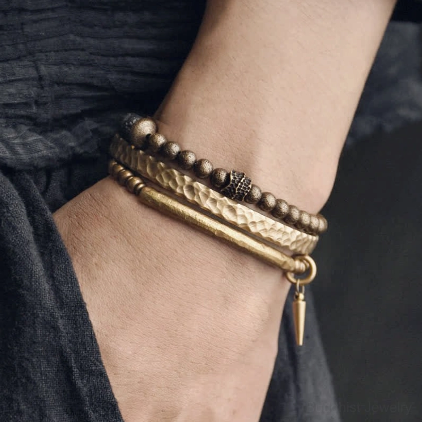 Lava rock copper balance bracelet worn on wrist showing hammered brass cuff and beaded stone strand together
