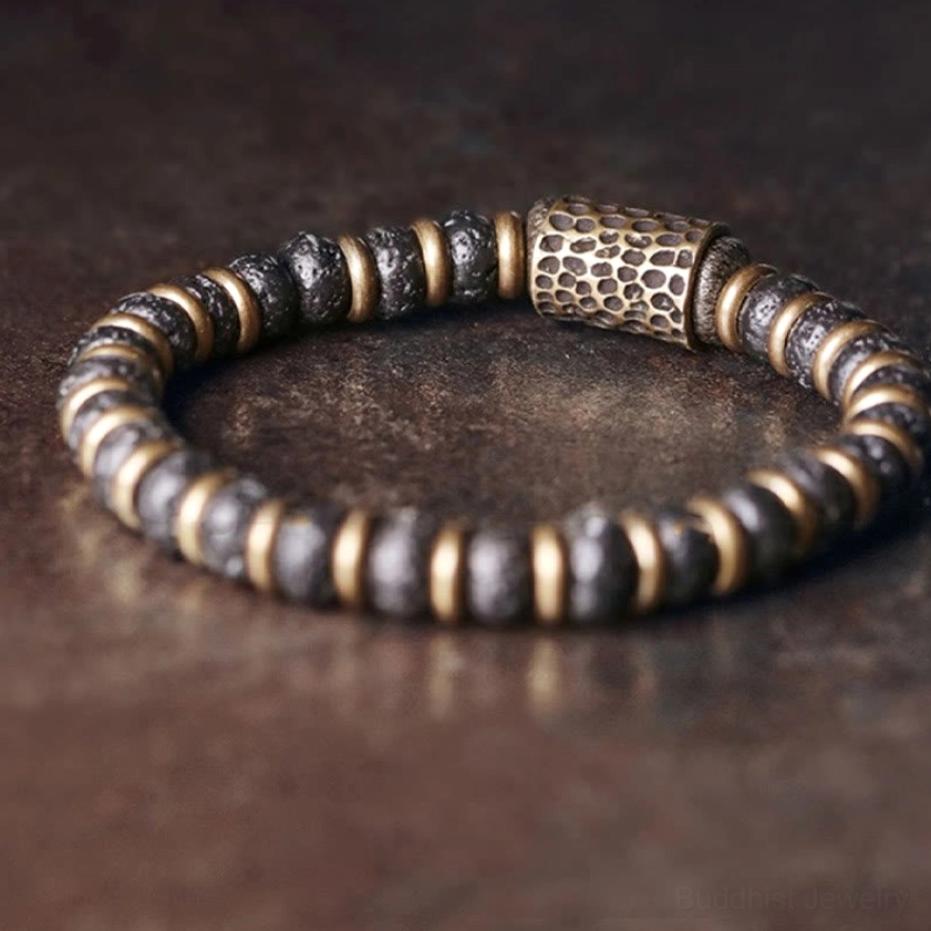 Flat lay detail of lava rock copper bracelet displaying hammered cylindrical copper bead and mixed stone metal beads