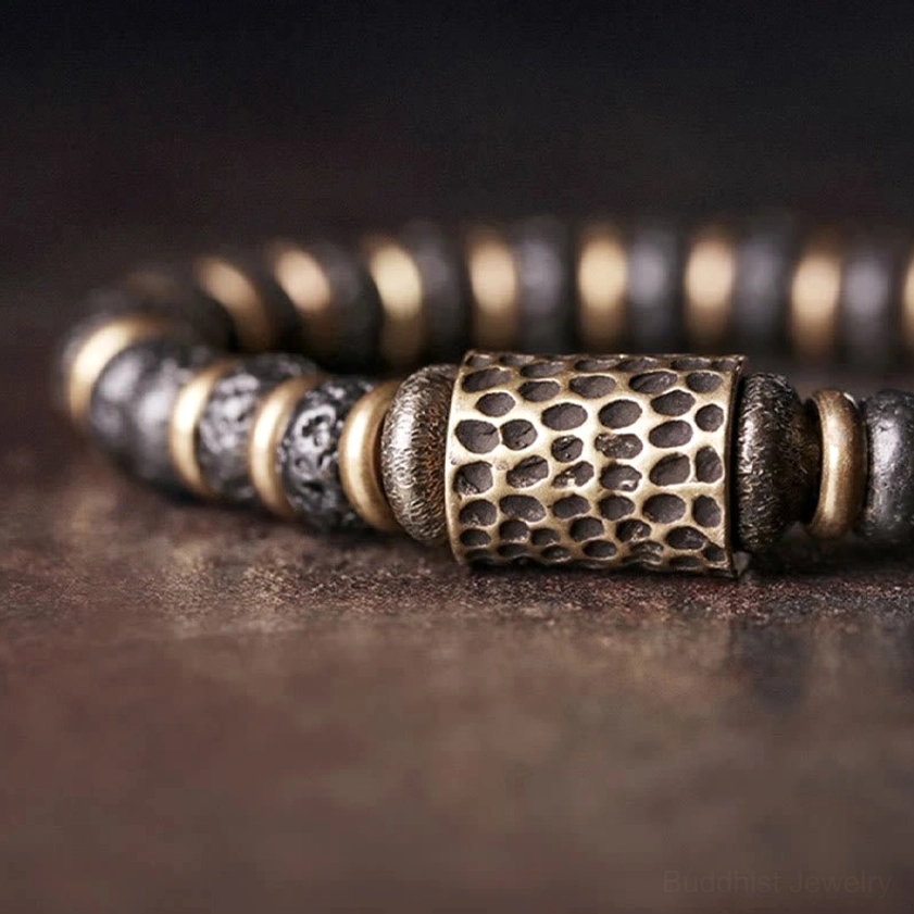 Close-up macro shot of hand-hammered copper barrel bead with lava rock stone bead segments