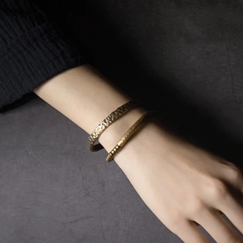 Lava rock stone beads and copper metal balance bracelet showing natural texture variations
