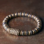 Lava rock copper bracelet top view showing hand-hammered copper accents and natural volcanic stone beads