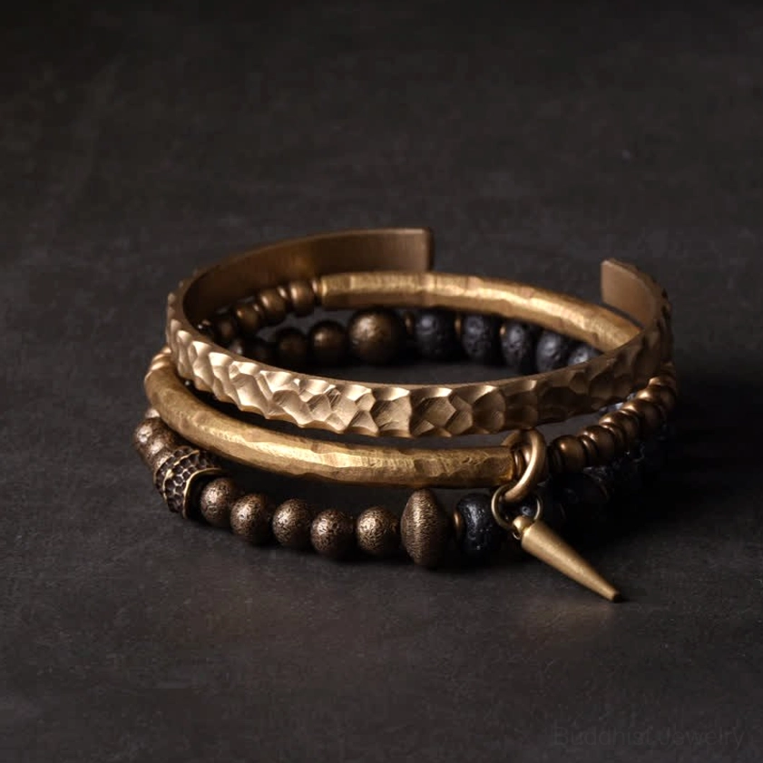Top-down flat lay view of lava rock and copper balance bracelet set showing layered design and mixed metal details
