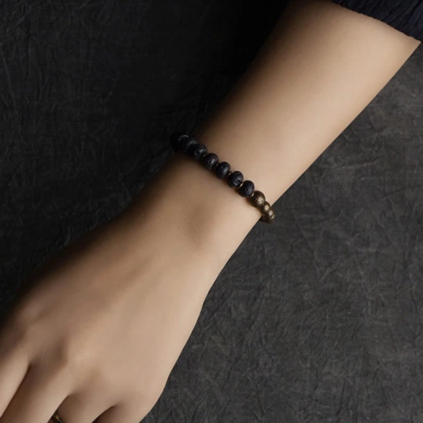 Lava rock and copper bracelet worn on wrist showing fit and design on skin tone