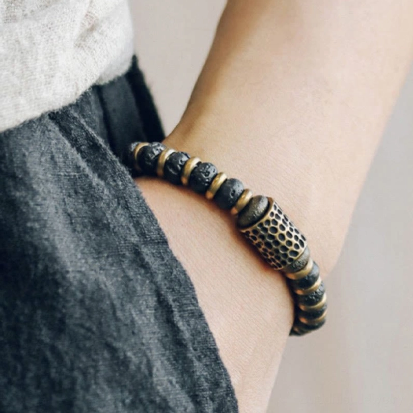 Lava rock copper bracelet worn on wrist in side profile showing bead pattern and fit on forearm