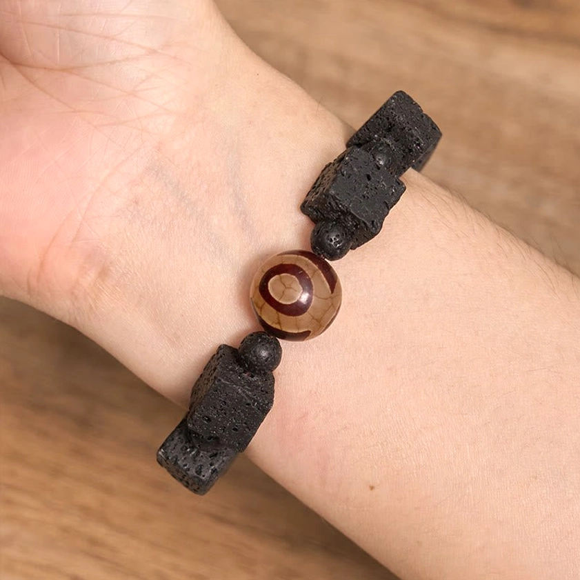 Lava rock dzi bead healing bracelet worn on human wrist showing comfortable fit and natural stone texture