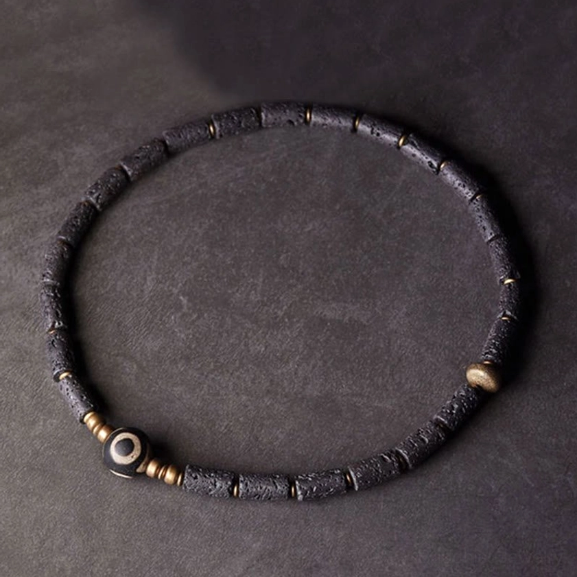Single-layer lava rock Dzi bead bracelet minimalist design with central three-eyed focal point