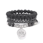 Lava rock lotus bracelet set with silver lotus charm displayed on white background - top view