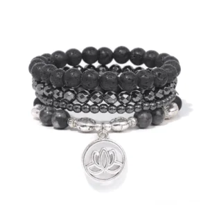 Lava rock lotus bracelet set with silver lotus charm displayed on white background - top view