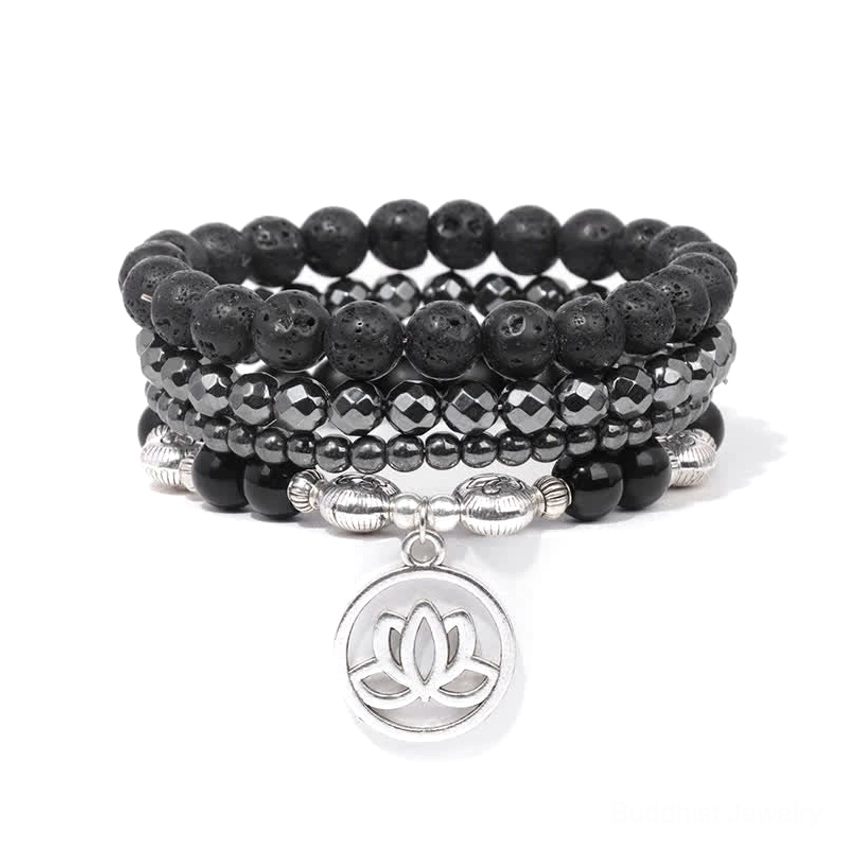 Black lava bead lotus bracelet with metal spacer beads and silver charm - overhead view