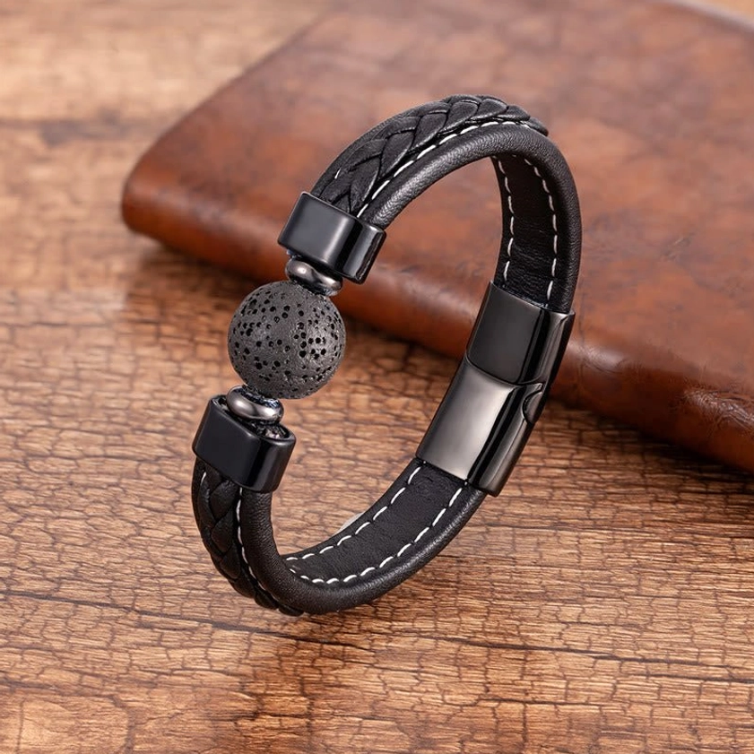 Lava Rock Om Mani Padme Hum leather bracelet featuring grey porous lava stone bead with black braided leather and metal hardware