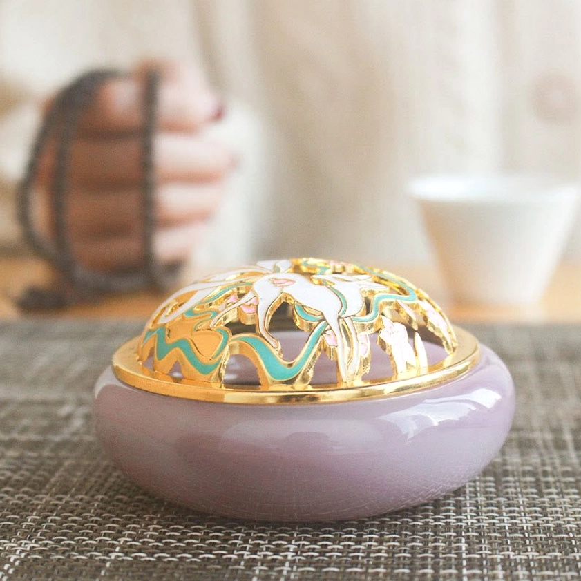 Matte lavender purple nine-tailed fox incense burner eye-level side view with gold-trimmed carved cloisonne lid in elegant minimalist zen tea setting