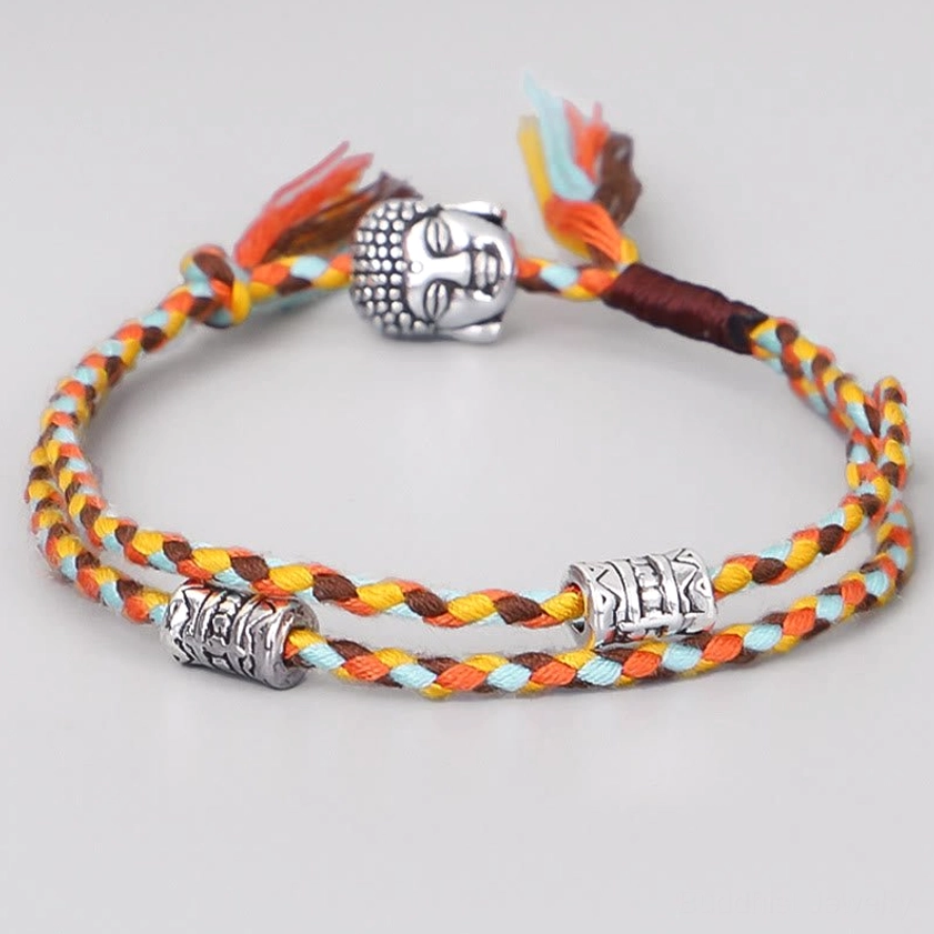 Light blue braided Buddha head string bracelet with silver alloy beads, front view on white background