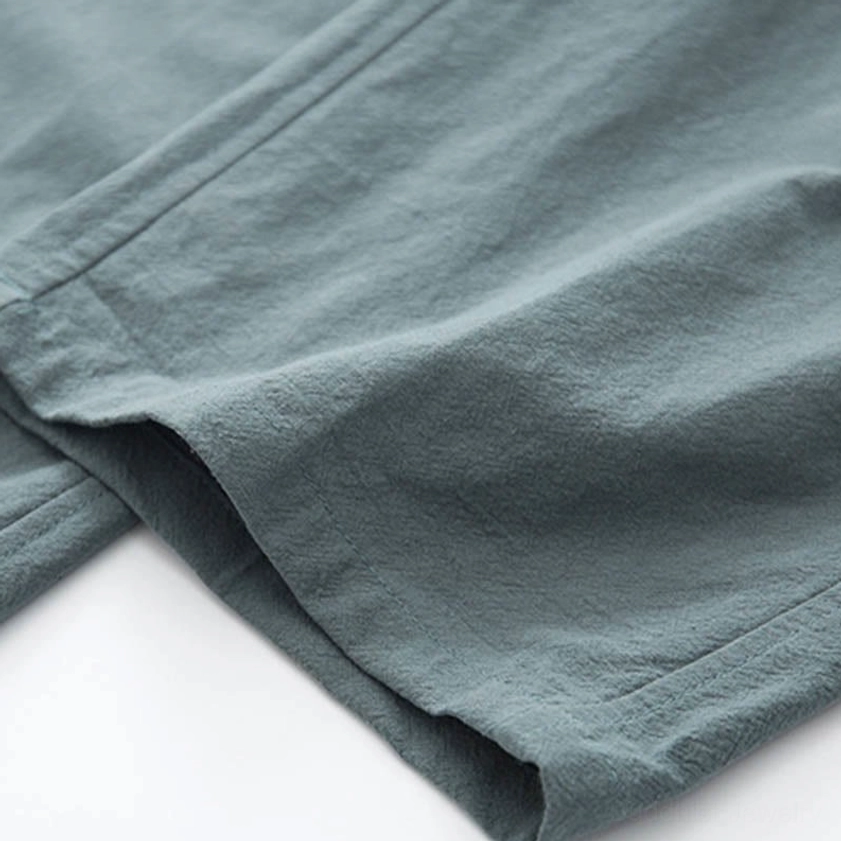 Full length front view of light cyan linen zen tang suit pants with functional side pockets for meditation wear