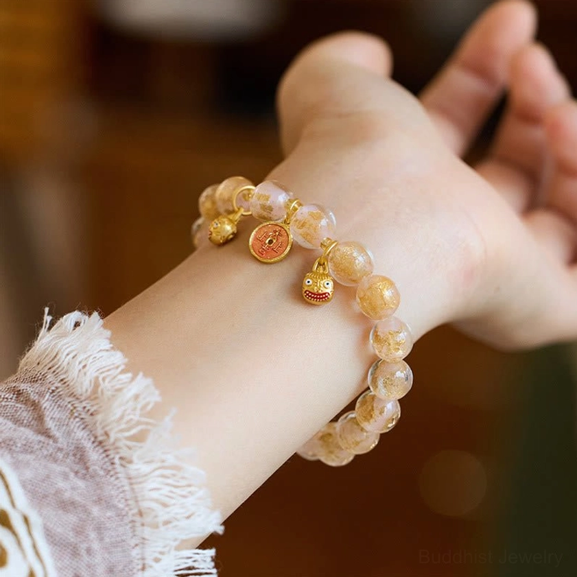 Light pink liuli glass bead Buddhist prosperity bracelet with gold swallowing beast charm and bell pendant