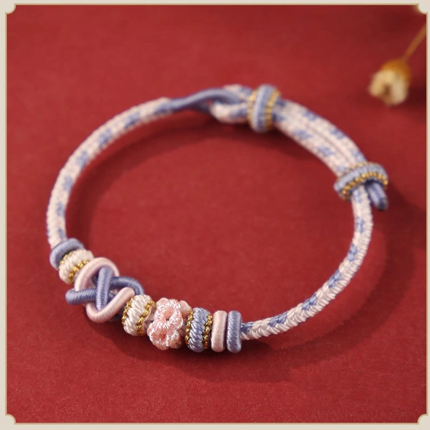 Light purple Buddhist peace knot bracelet flat lay - handcrafted for spiritual awakening and higher consciousness