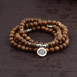 Lightning strike wood Buddhist mala bracelet with lotus silver pendant, handmade meditation beads on dark background