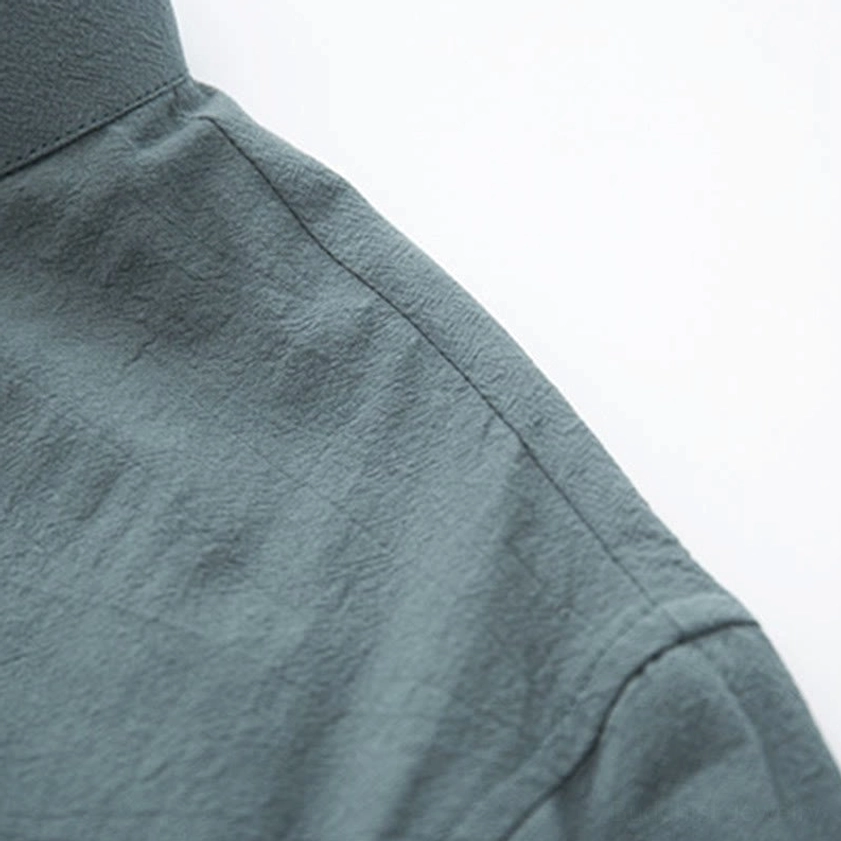 Linen fabric texture detail showing natural wrinkled weave and solid teal color of zen meditation wear