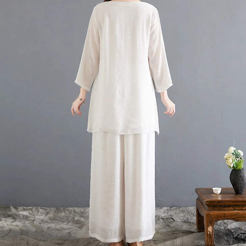 Back view of women's linen meditation clothing set featuring long sleeve top and wide-leg trousers for yoga and contemplative practice