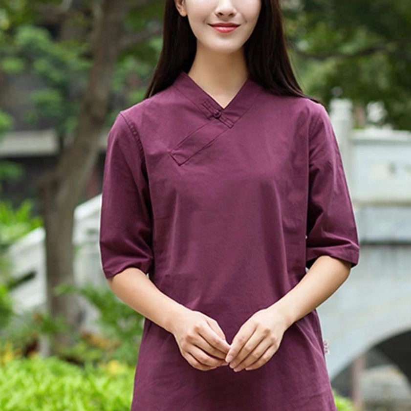Burgundy linen meditation and Tai Chi top with slanted V-neck collar and half sleeves in traditional garden setting