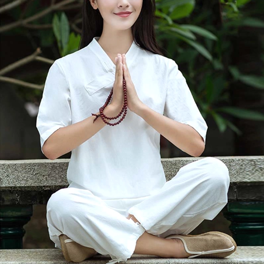 Pure white linen Tai Chi and meditation set with slanted collar half sleeves and loose comfortable pants on garden stone platform