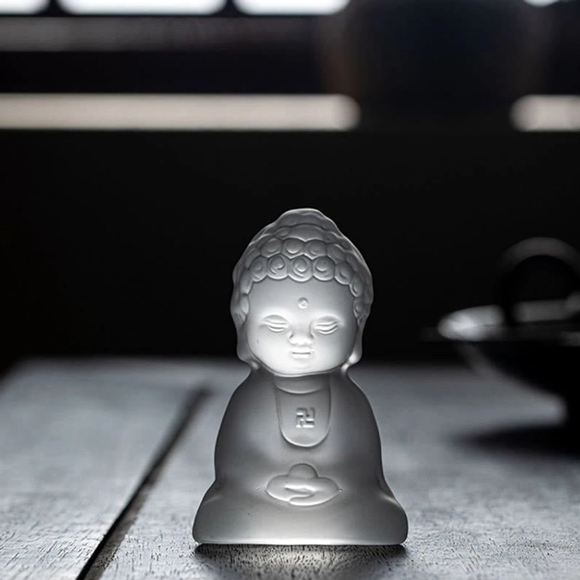 Hand-carved Liuli Buddha ornament with detailed curled hair buns and serene expression