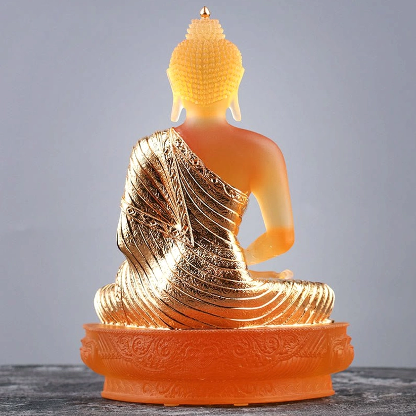 Back view of handcrafted Liuli glass Buddha statue showing carved robe texture detail with lotus seat base