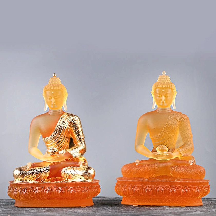 Pair of matching gilt glass Buddha statues with amber frosted finish and lotus bases, identical design handcrafted figurines