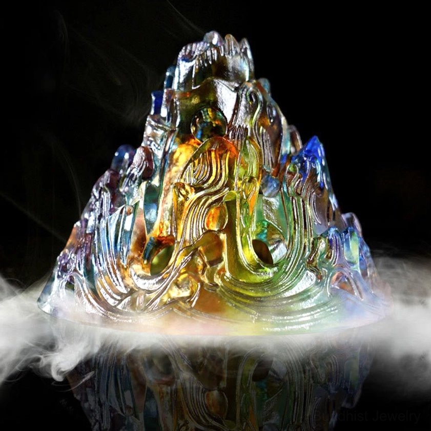 Translucent Liuli glass mountain incense lid with carved wave patterns and floating smoke against dark background